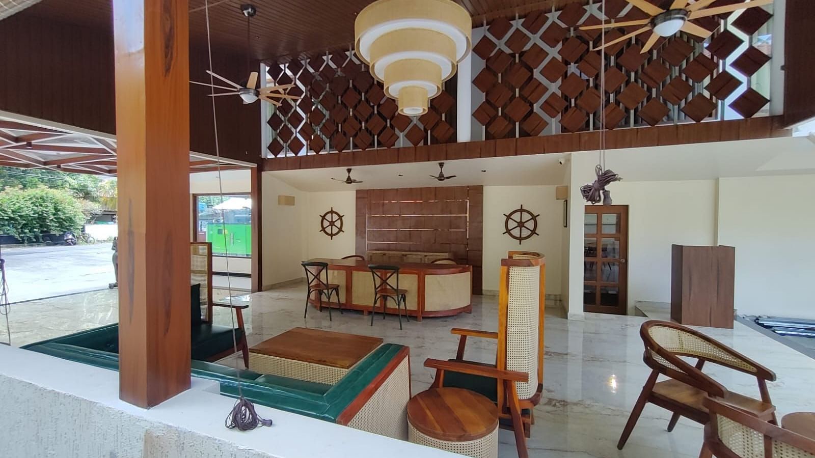 Image of an open air dining section at the resort featuring a decor made out of wood  | Arina Island Resort