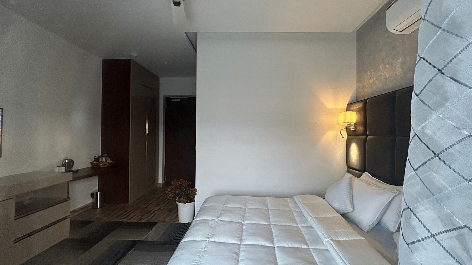 a deluxe room with modern interiors featuring a double bed at Eminence The Corbett