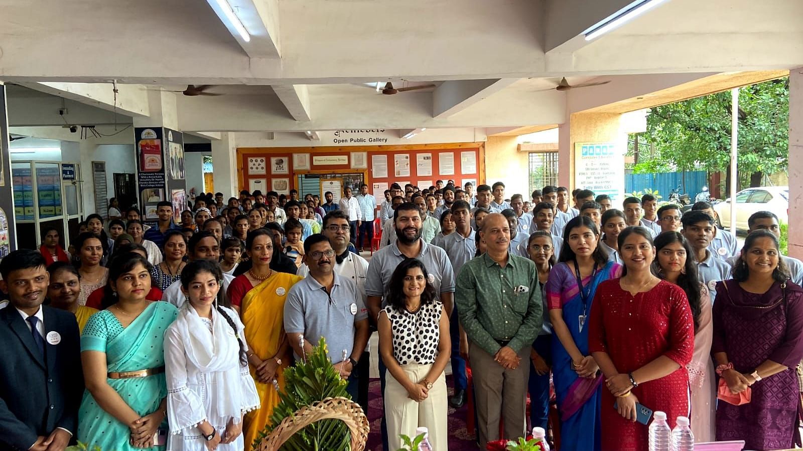 Crowd gathered inside the college lobby for an event - Kamats India