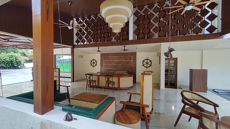 Image of an open air dining section at the resort featuring a decor made out of wood  | Arina Island Resort