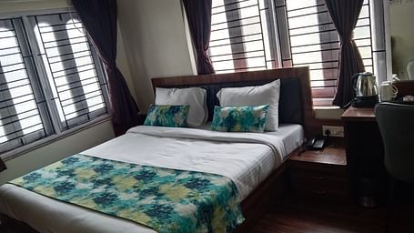 side view of the double bed inside Premium Room without Balcony - Ecotel Kolkata