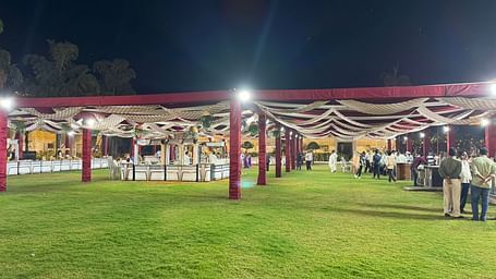 an outdoor banquet hall in Basar at Lords Hrim Akshara Resort Basar decorated with red canopy, and several counters located at different spots