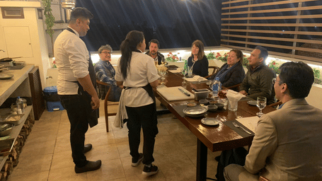 Guests enjoying a fine dining experience on an open-air rooftop terrace restaurant in Lalitpur, Kathmandu Valley, Nepal.