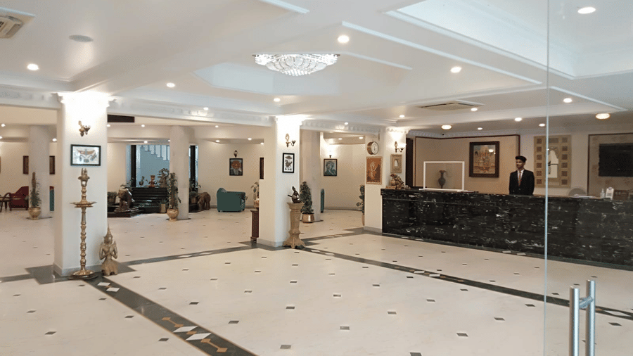 A spacious hotel lobby with seating and reception area at A S Hotels, Khajuraho.