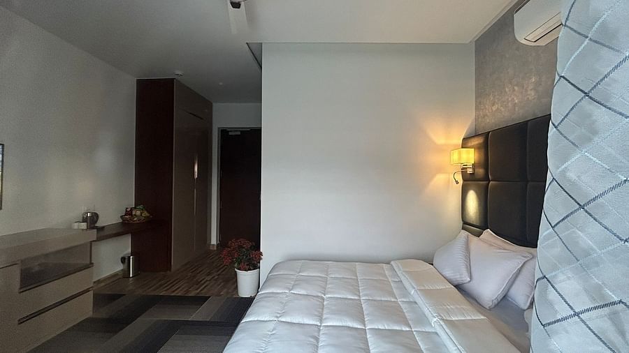 a deluxe room with modern interiors featuring a double bed at Eminence The Corbett