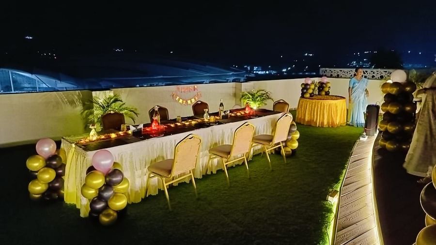 outdoor event space with a huge table and chairs placed with lavish decoration at Hotel Eastern Gate, Port Blair