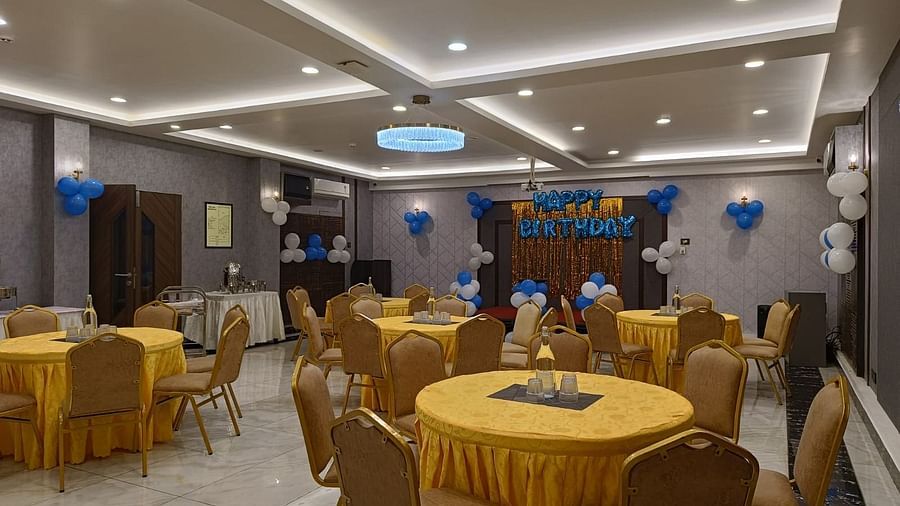 event hall with yellow chairs and tables at Hotel Eastern Gate, Port Blair