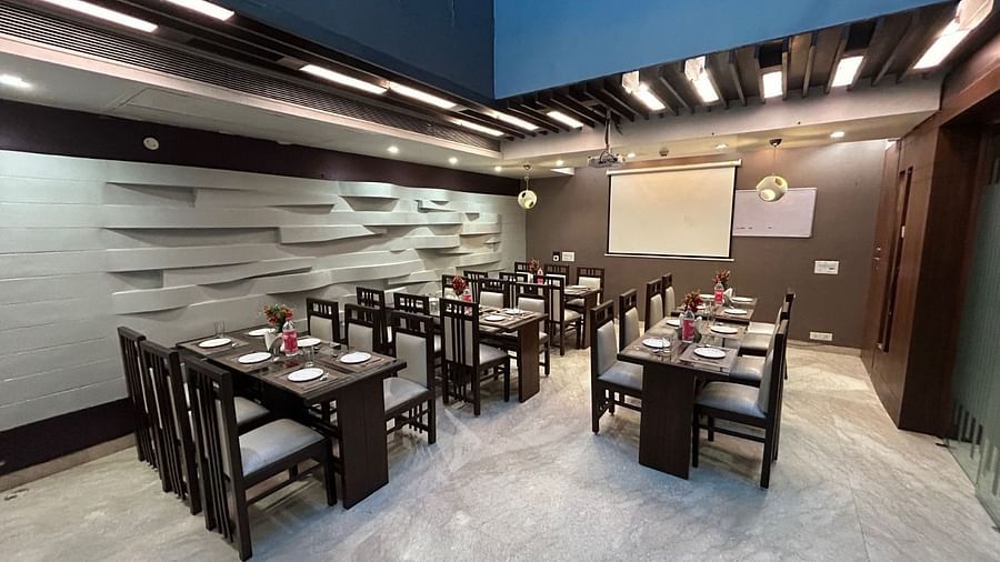 A vibrant restaurant interior with organised seating, sophisticated decor, and ample space for gatherings - Hotel Emerald, Chandigarh