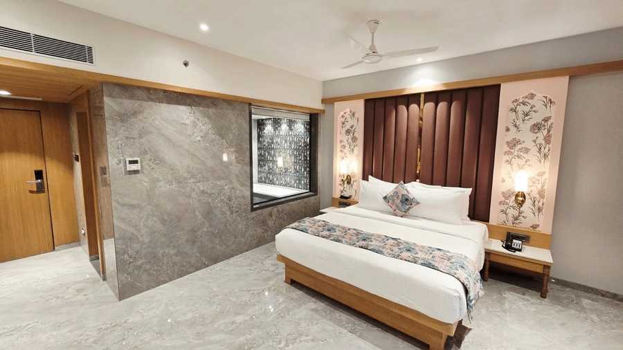 Well-appointed room with bed, sofa, and warm lighting at Hotel Mumbai House, Digha, Airoli.