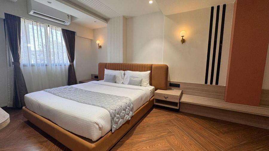 Bright bedroom at Hotel Mumbai House, Vijay Nagar, Indore, featuring modern furnishings, soft bedding, and chic interiors for a welcoming experience.