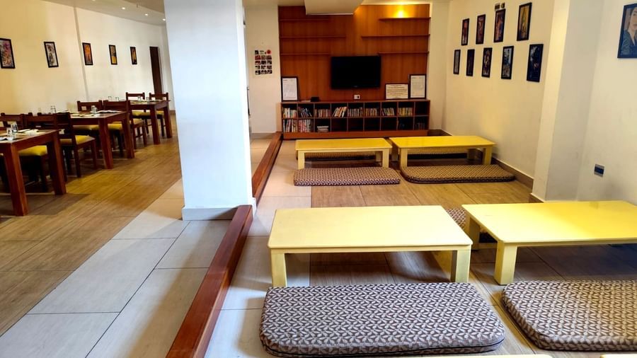 Seating arrangement on the floor at Ajito restaurant with pale yellow coloured tables surrounded with cushioned mattresses at Ilara Hotels & Spa, Tada.