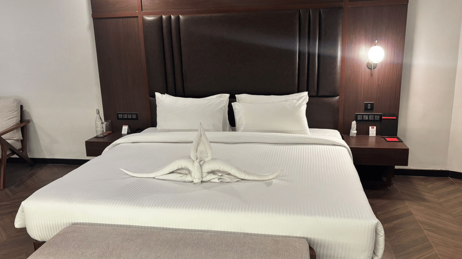 Close-up of comfortable bed with white linens at Lords Riverside Resort, Muduba - Shivamogga