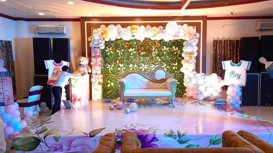 A event hall in Roorkee decorated for a celebration with balloons and a sofa - Motel Divine International, Roorkee