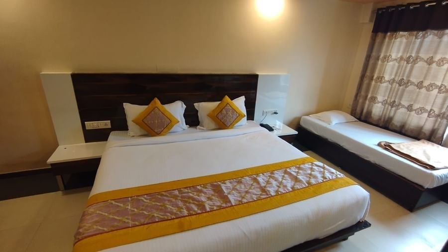King size bed and single bed in the Super Deluxe Room of Mountview Resort.