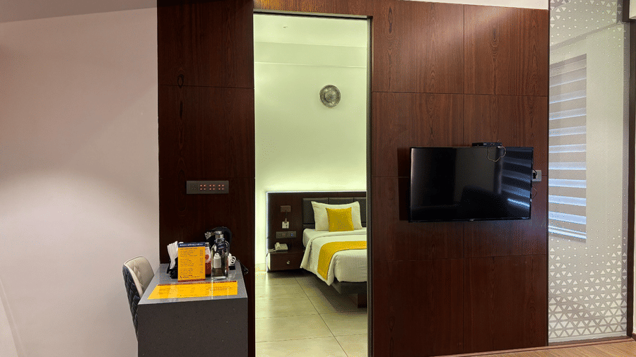 A narrow door frame leading tot he bedroom of the Premier Suite at SRS Suites, Koramangala.