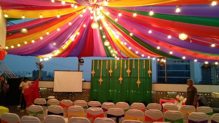 Image of an outdoor event space with chiars and light above at The Oriental Residency