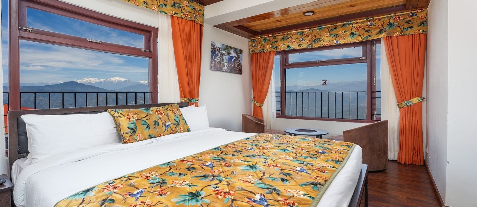 Image of a room with two large windows and a bed at Summit Sherpa Mountain Hotel & Spa, Kalimpong