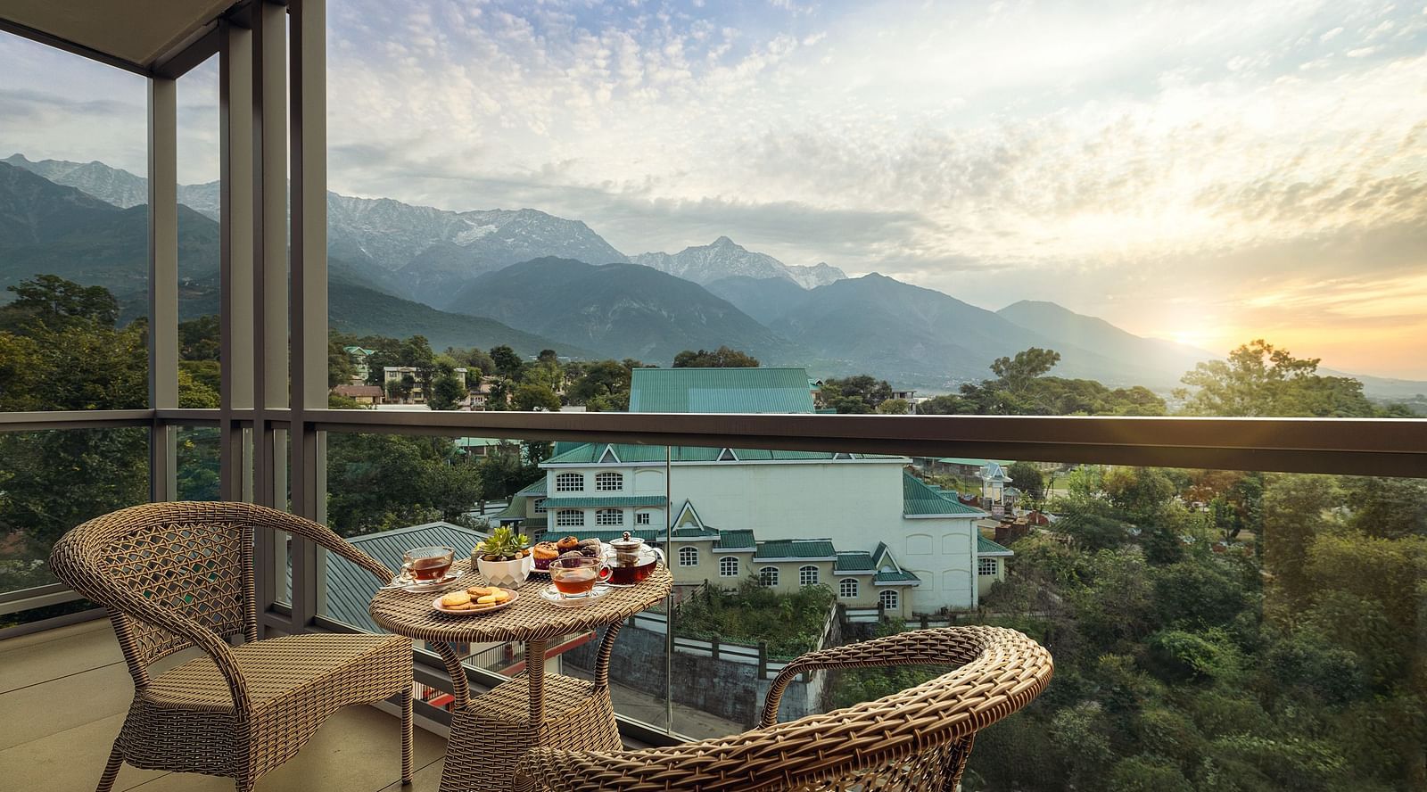 Premium peaks balcony area with a coffee table and chairs with mountains in the backdrop