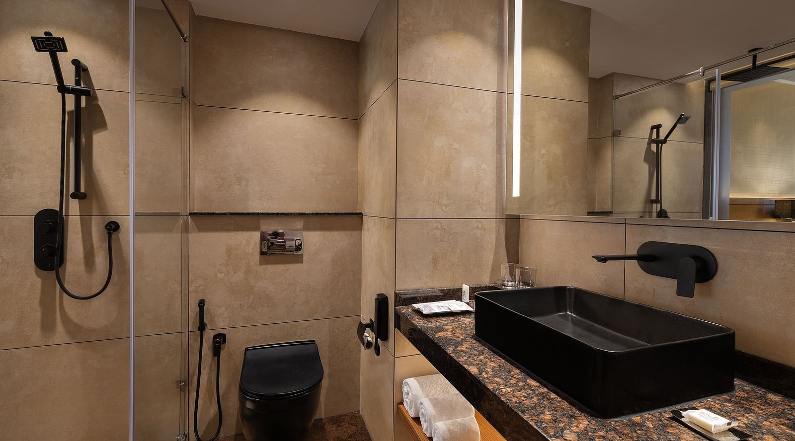 Premium peaks washroom vanity area with black faucets