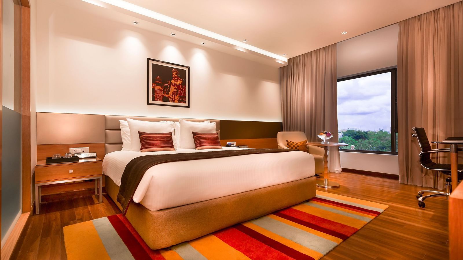 Business Class Room with a king size bed and a TV at Grand Chennai By GRT Hotels.