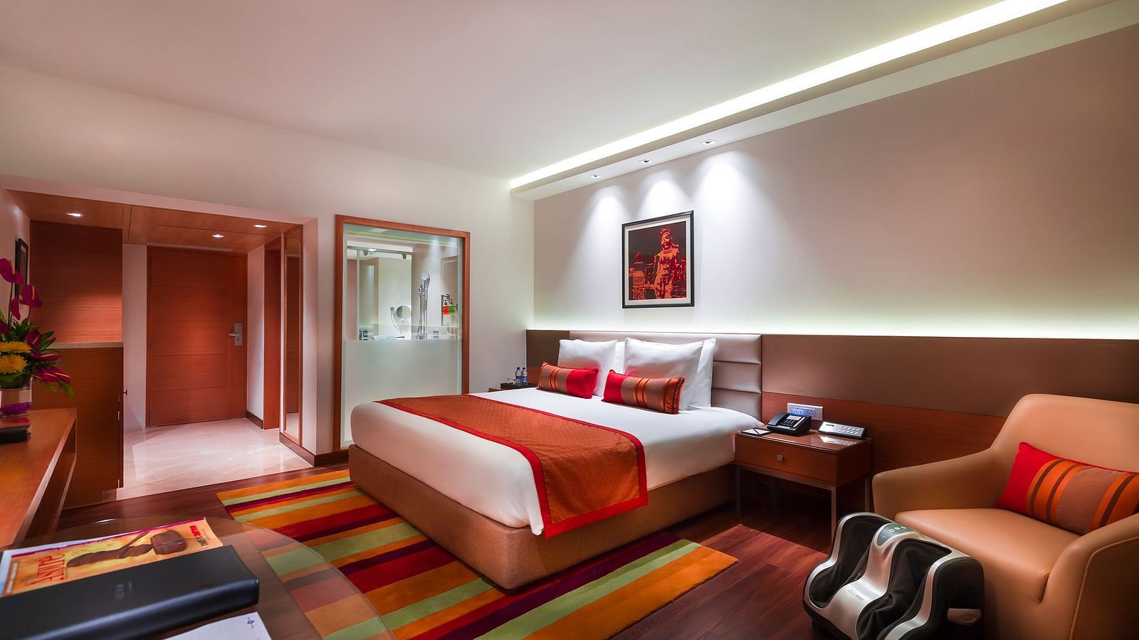 Grand Club Room with king size bed and sofa chair at Grand Chennai By GRT Hotels.