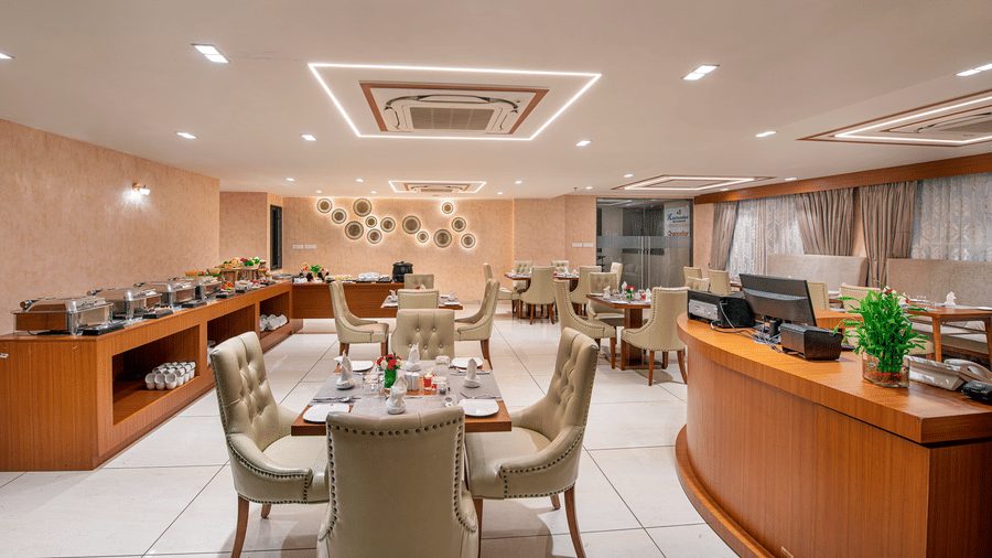 A hotel buffet area with food warmers and serving stations, ready for guests - SK Lords Inn Ahmedabad