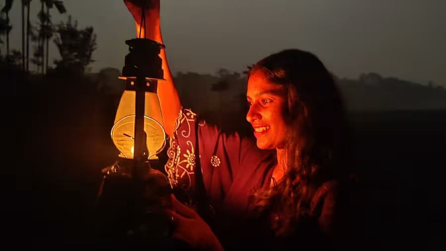 A woman holding a lantern in the dark with a moon shining in the background - Evergreen County