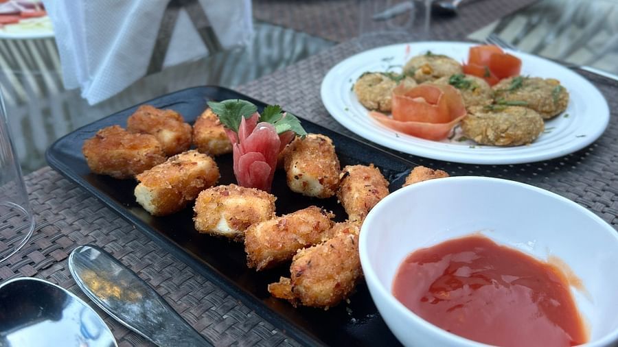 A close up shot of food platters served with snacks laid on a table with cutlery - DLS The Emerald, Nanital