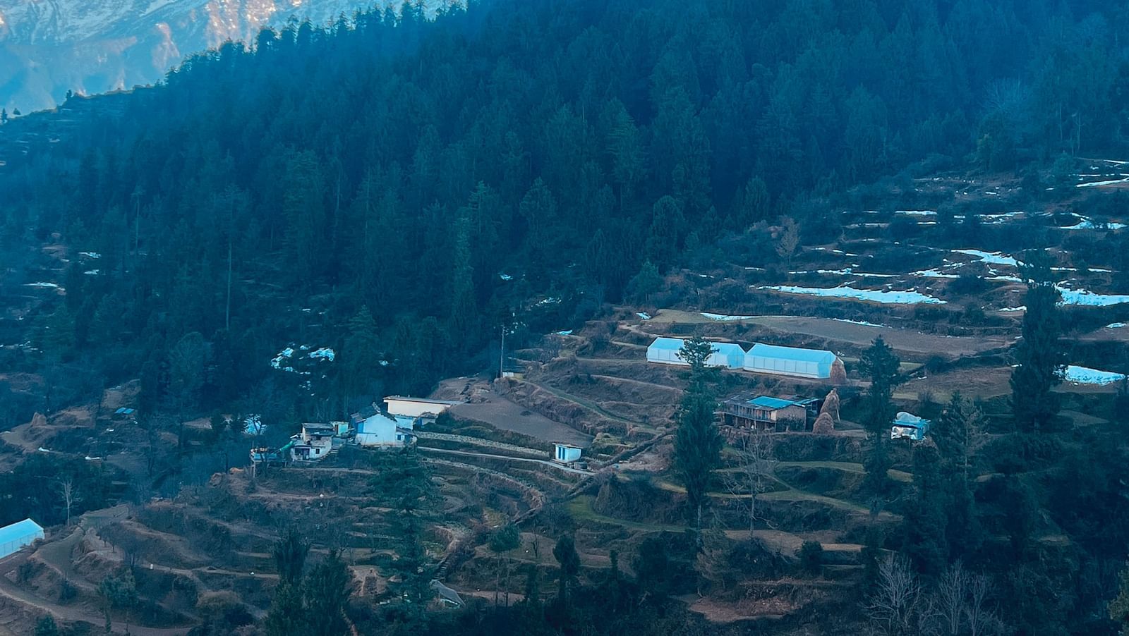 Aerial view of a village with mountians in the background | Faraway Cottages, Auli