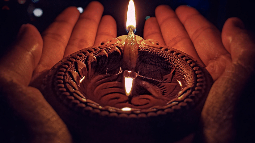 A diya being held