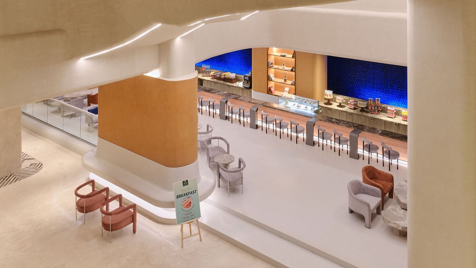 View of the Bean Hive dining area at Swosti Premium Beach Resorts, Puri, showcasing a buffet and elegant interior design creating a sophisticated dining atmosphere