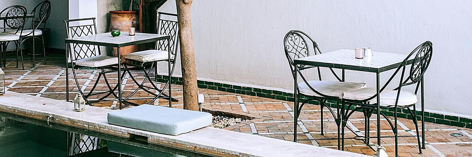 A plunge pool inside a hotel with seating arrangement besides it
