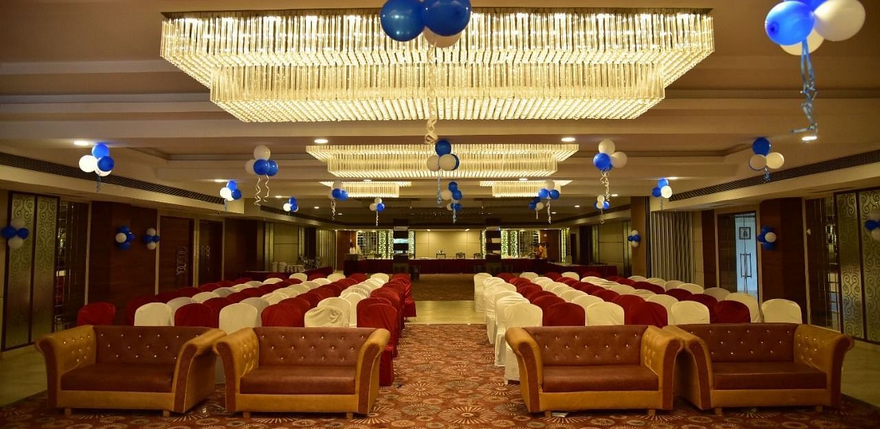 A decorated banquet hall at Rang Lords Inn, with arranged seating and festive balloons, prepared for a celebration or event