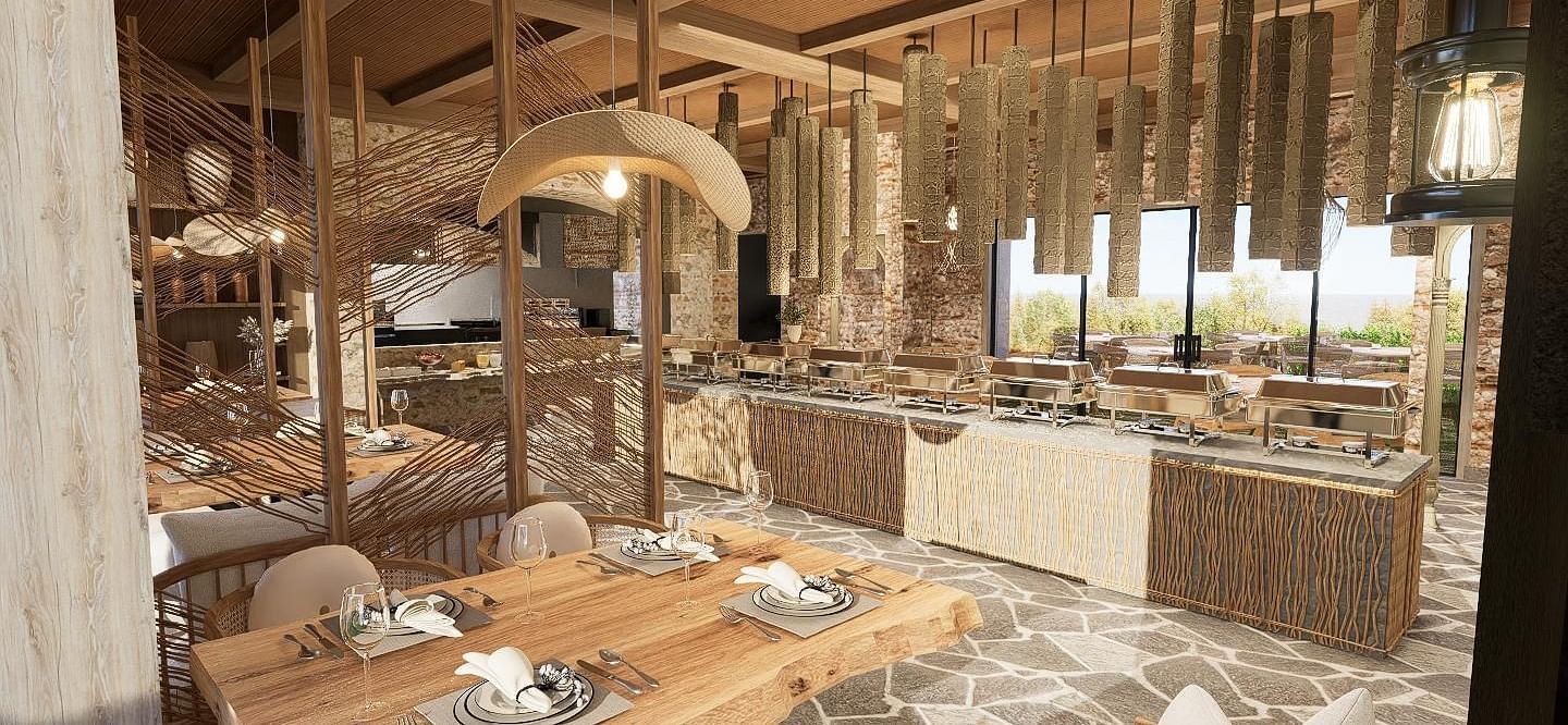 Diagonal view of the restaurant with neatly set tables and chairs, featuring a central table with a buffet setup at The Evren, Vagator.