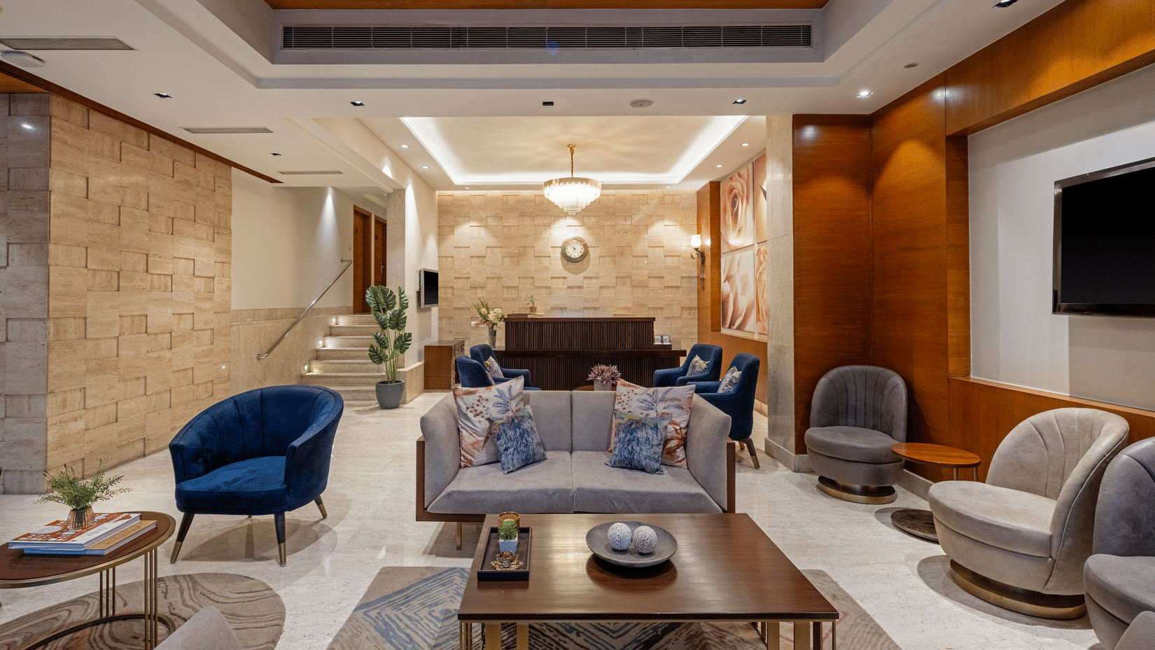 Spacious and luxurious hotel lobby of Hotel Saket 27 featuring modern seating arrangements, ambient warm lighting, stylish décor, and a welcoming atmosphere for guests