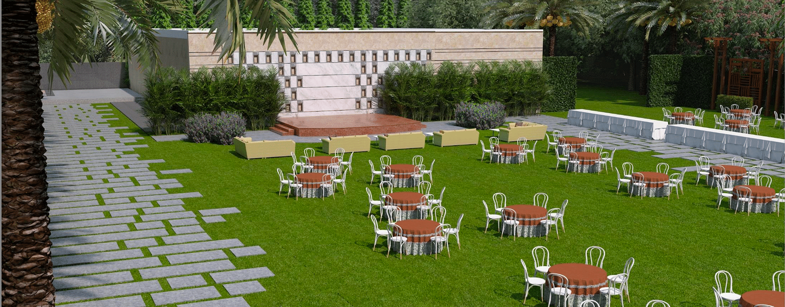 A wide view of lawn with stage, tables, and chairs on grass, stone pathways on either side, and palm trees around the area at Merlis Hotel, Coimbatore