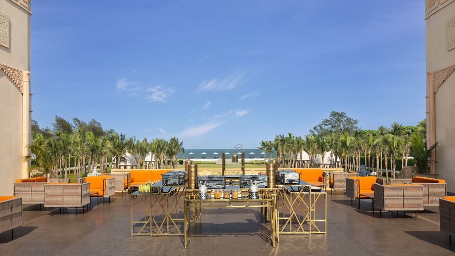 The high tea place at our resort in Mahabalipuram offering cosy orange chairs, a snack counter, and views of the Bay of Bengal – Kaldan Samudra Palace, a stunning luxury resort in ECR