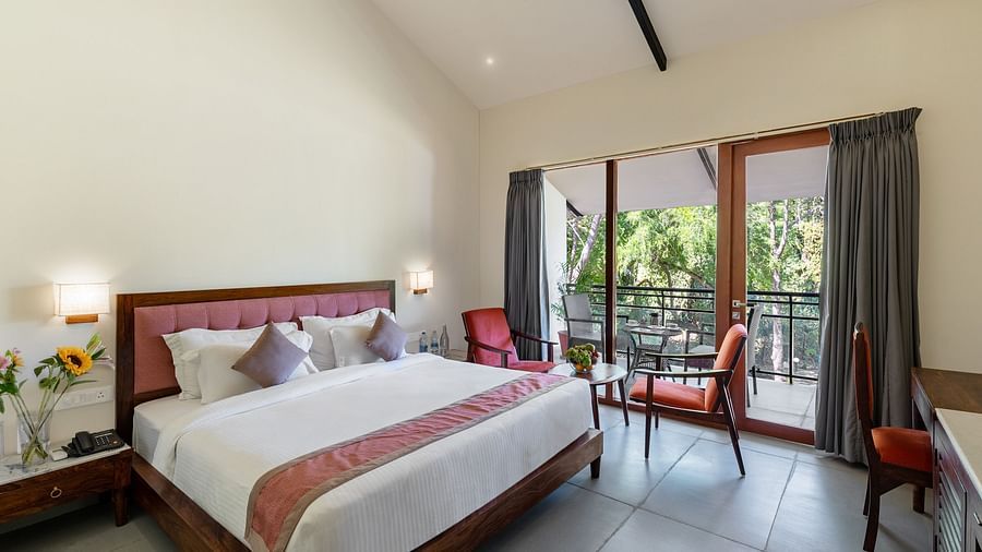 image of the luxury cottage room at aranya vilas featuring a plush king size bed 