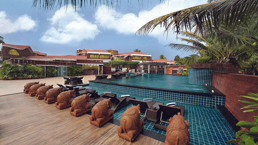 Relaxing poolside lounge area with sunbeds at MAYFAIR Heritage, Puri