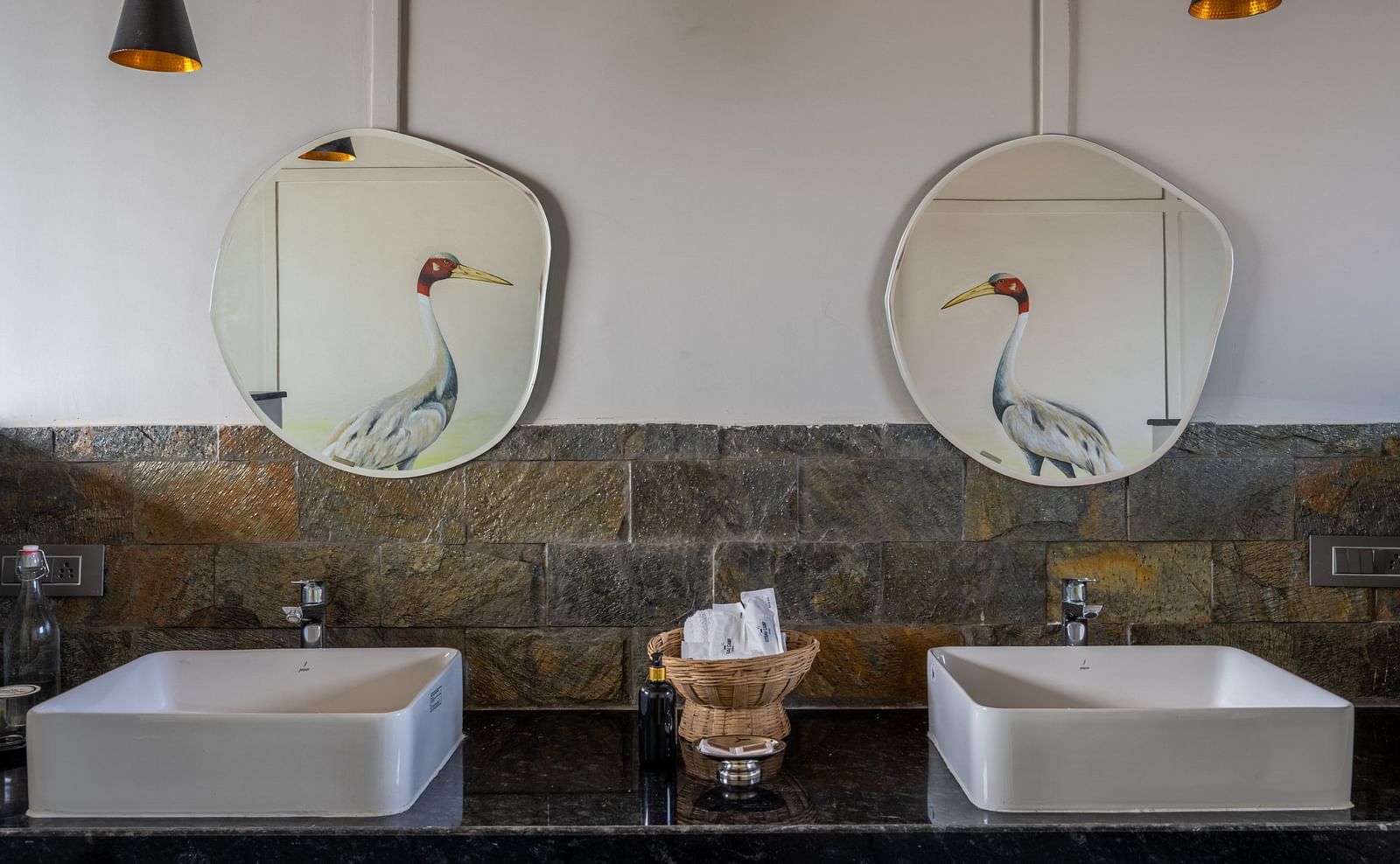 An image of a washroom with two wash basins and mirrors - Utsav Camp Sariska