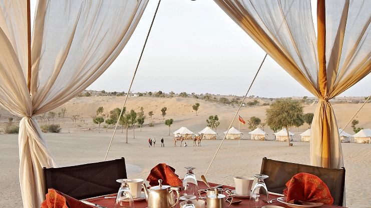 A close up shot of the outdoor dining arrangement over the arid desert region - MANVAR Resort & Desert Camp