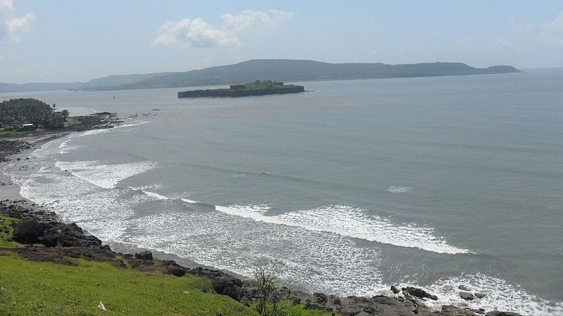 A scenic view of the Murud beach with greenery on one side of the coast