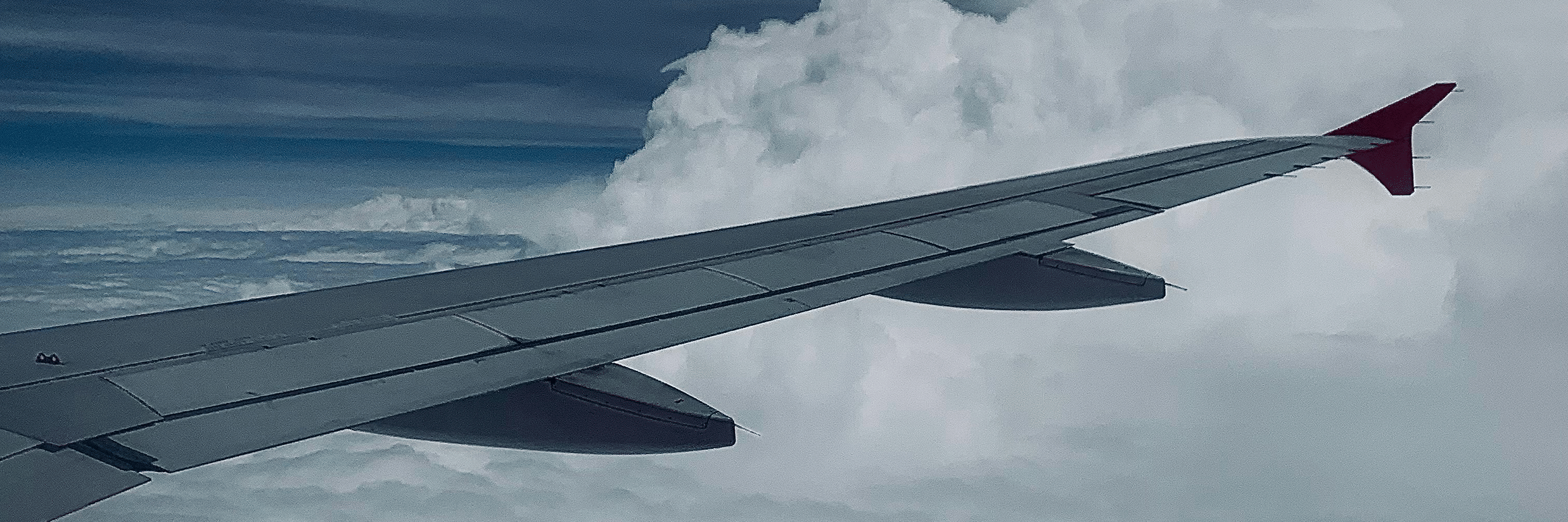 Wing of a flight from Chennai to Goa mid-air featuring clouds