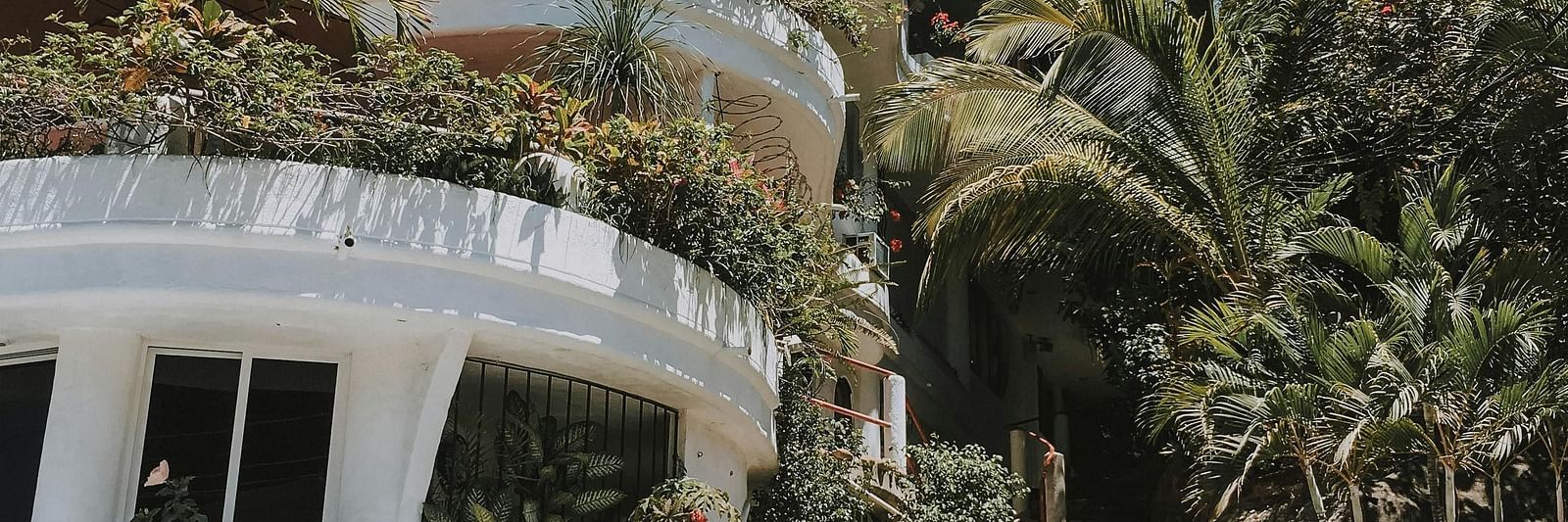 Facade of a hotel with trees surrounding it