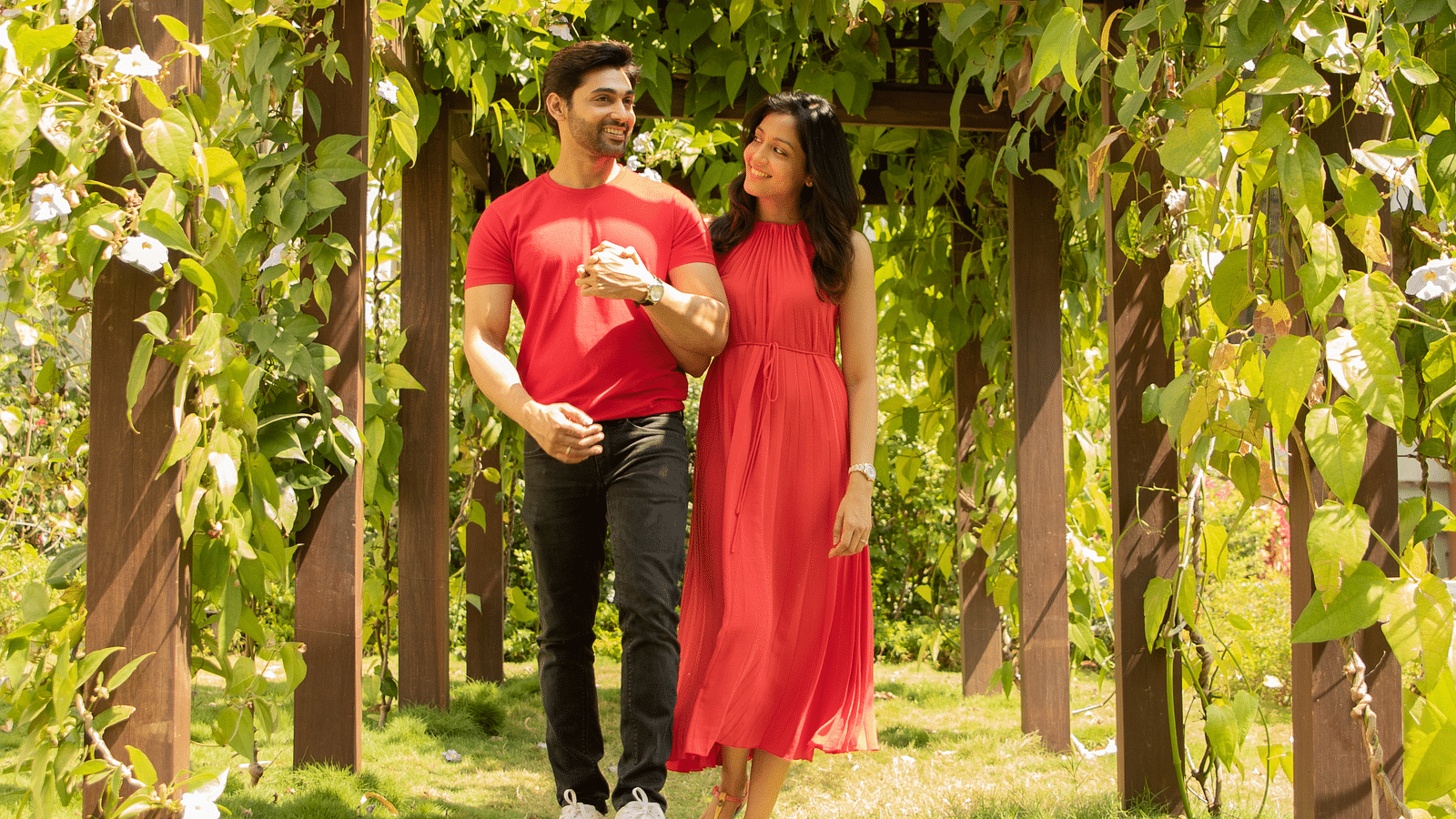 an image of a couple walking through green pathway in garden - Rhythm Lonavala