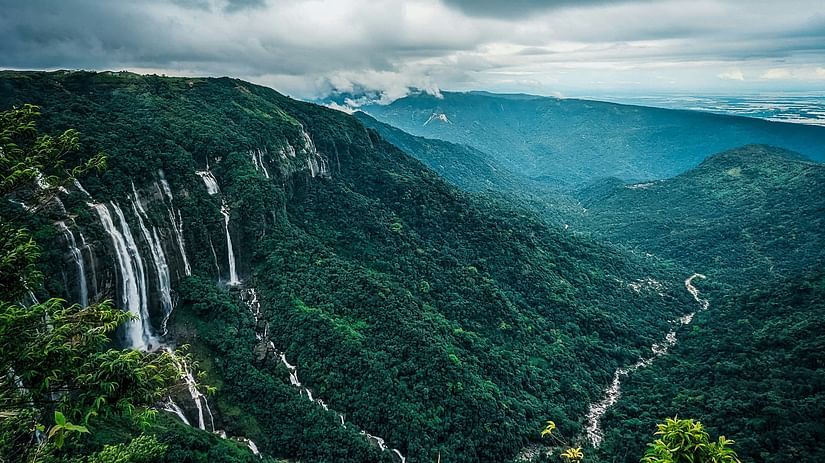 an aerial view of the many waterfalls cascading down from a mountain side in Cherrapunjee