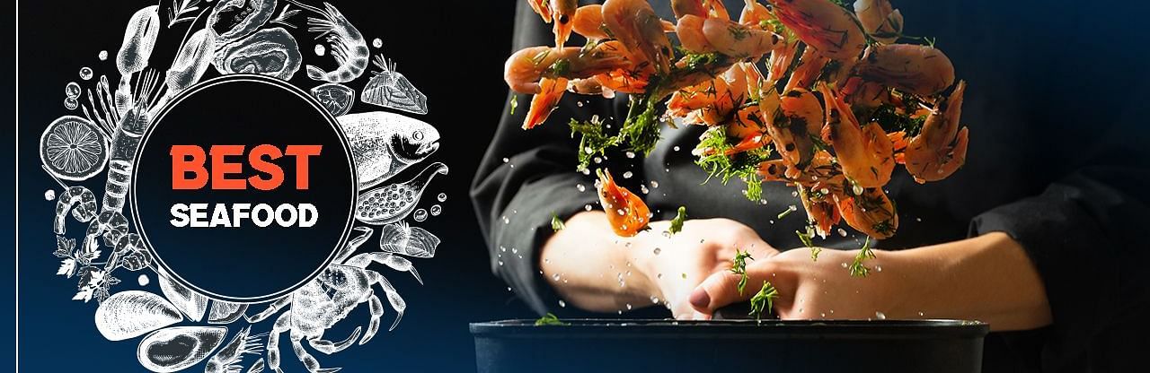 Plated seafood dish with the text, Exploring the Best Seafood in Andaman at Mansha Hotels.