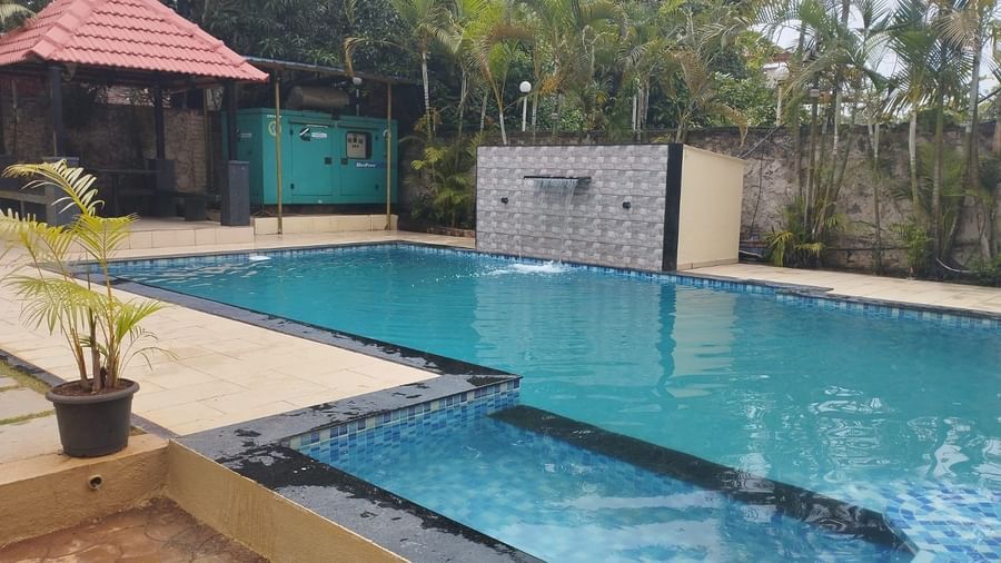 Outdoor pool area at Mountview Resort in Lonavala, featuring a gazebo by the side.