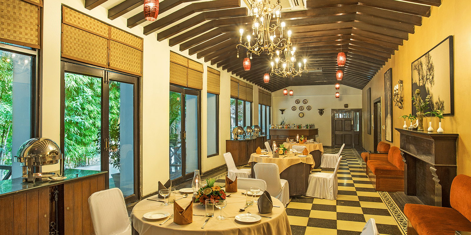 An image of a dining area with many table and chairs and a huge chandelier hanging from the ceiling- The Riverview Retreat, Corbett