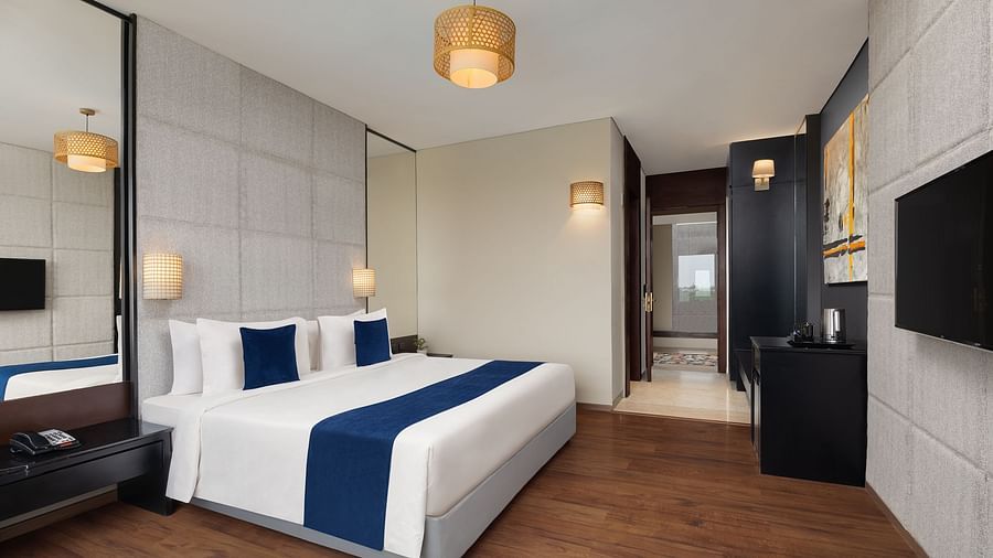 Premium Room at Essentia Luxury Hotel, Indore with a double bed and a television